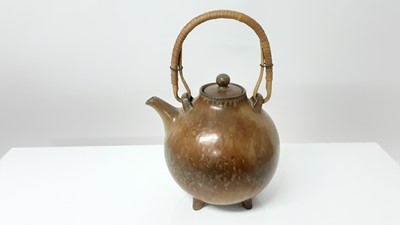 Lot 1354 - Rare 1960s fur glaze teapot by Gunnar Nylund for Rostrand with wicker handle, 16cm high