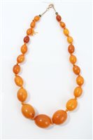 Lot 737 - Old amber bead necklace with a string of...