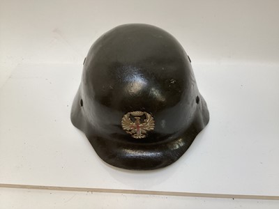 Lot 767 - Spanish private purchase army officer's parade helmet, in green painted finish with royal badge on front and leather liner.