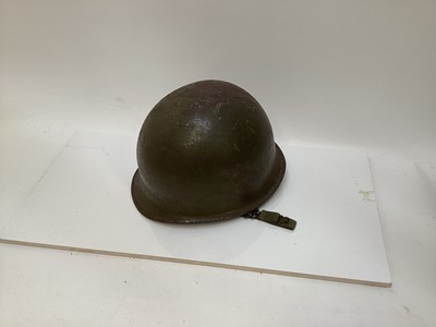 Lot 782 - American M1 steel helmet with projectile damage possibly Vietnam War era with earlier shell and liner.