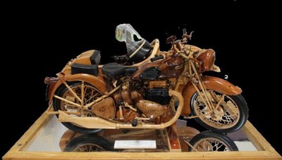 Lot 2112 - Fine quality scratch built model of an 1938 1000CC Ariel Square Four, by Philip Miller 2007, beautifully constructed in specimen woods with working steering, mounted to a mirrored display base, enc...