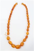 Lot 738 - Old amber bead necklace with a string of...