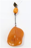 Lot 739 - Old amber pendant, the large polished amber of...