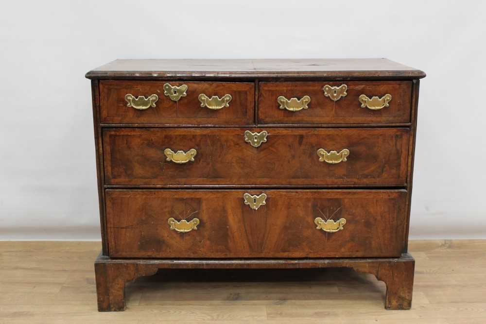 Lot 1302 - Early 18th century walnut veneered chest of two short and two long drawers