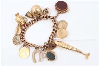 Lot 744 - Gold charm bracelet with a collection of gold...