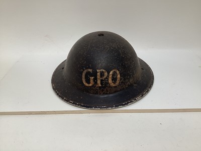 Lot 858 - Second World War British MKII steel helmet, with black painted finis and label for GPO (General Post Office) to front, with liner and chinstrap, dated 1939.