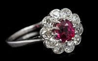 Lot 757 - Ruby and diamond cluster ring, the flower-head...