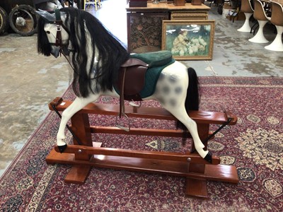 Lot 1868 - Haddon rocking horse, the dappled horse with green suede and brown leather saddle, on a pine base, 113cm high