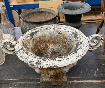 Lot 145 - Antique iron cauldron, together with two cast iron garden urns