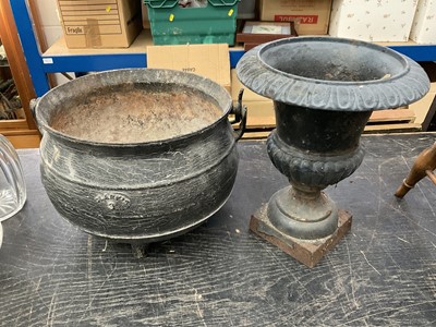 Lot 145 - Antique iron cauldron, together with two cast iron garden urns