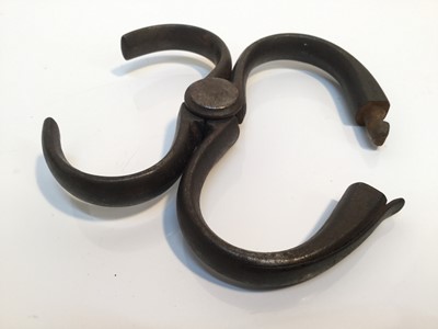 Lot 850 - Unusual pair of late 19th century Police steel horse shoe hand cuffs by Haitt, Birmingham, 13cm in overall length