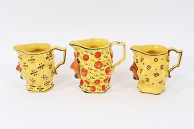 Lot 11 - Set of three early 19th century Staffordshire canary yellow Satyr-mask jugs
