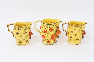 Lot 11 - Set of three early 19th century Staffordshire canary yellow Satyr-mask jugs