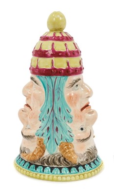 Lot 17 - Staffordshire pearlware-glazed stirrup cup, early 19th century, moulded on each side South a double face representing the Pope and the Devil, 14.5cm high