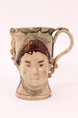Lot 18 - Prattware loving cup, circa 1790, modelled to two sides with masks of the Royal couple George III and Queen Charlotte, impressed 'GOD SAVE THE KING AND GOD SAVE THE QUEEN' around the rim, washed in...