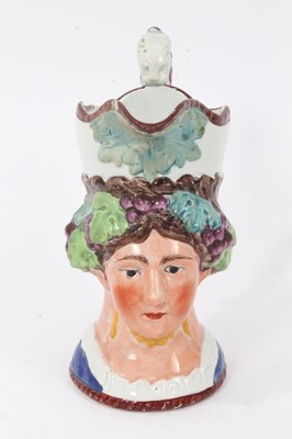 Lot 20 - Staffordshire Pearlware character jug, early 19th century, in the form of a woman with grapevines around her head, the scrollwork handle with lion-form terminal, 17cm high, together with two simila...