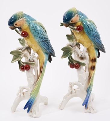 Lot 24 - Pair of Karl Ens porcelain models of parrots picking cherries, model number 7622, 32cm high