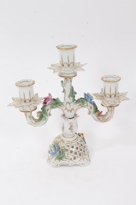 Lot 28 - Group of continental porcelain, including a pair of Dresden figures, four Dresden parrots, a set of six chocolate cups and covers decorated with fruit, a candelabra and a floral-encrusted plinth
