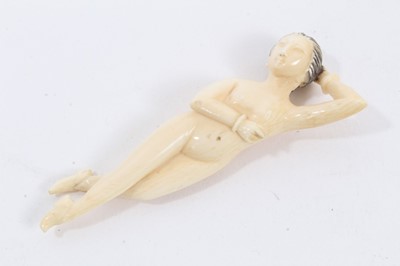 Lot 792 - Late 19th / early 20th century Chinese carved ivory medical figure of small proportions, in the form of a reclining naked lady, wearing shoes. 6.5cm overall length.