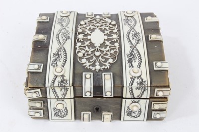 Lot 791 - Mid 19th century Vizagapatam horn and ivory mounted games box, with four removable compartments, containing eight circular and eight rectangular ivory floral decorated counters. Box 10.5cm across.