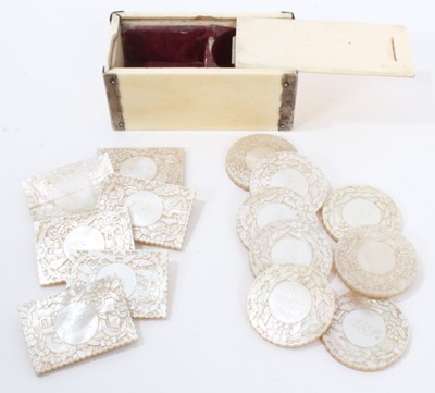 Lot 819 - 19th century Chinese ivory and white metal box with sliding cover, containing a set of fourteen heavily carved mother of pearl counters, with engraved monograms (Six rectangular and eight circular)...