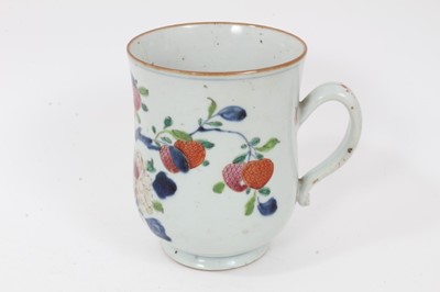 Lot 42 - Chinese export porcelain tankard, late 18th century, of baluster form, painted in underglaze blue and enamels with flowering and fruiting branches, 15.75cm high