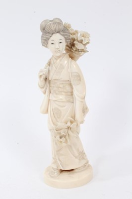 Lot 735 - Late 19th century Japanese carved ivory figure of a girl wearing traditional dress carrying flowers