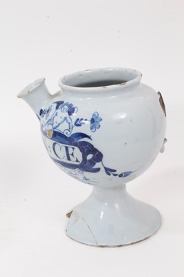 Lot 84 - Two 18th century English blue and white delft wet drug jars, of bulbous form, inscribed 'O.ABSYNTH' and 'S:E SPIN: CE' within cartouches supported by winged cherubs, 18.5cm high
