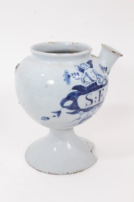 Lot 84 - Two 18th century English blue and white delft wet drug jars, of bulbous form, inscribed 'O.ABSYNTH' and 'S:E SPIN: CE' within cartouches supported by winged cherubs, 18.5cm high