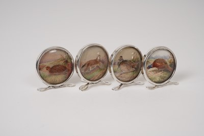Lot 231 - Set of four 1920s silver mounted menu holders, each decorated with a picture of a gamebird