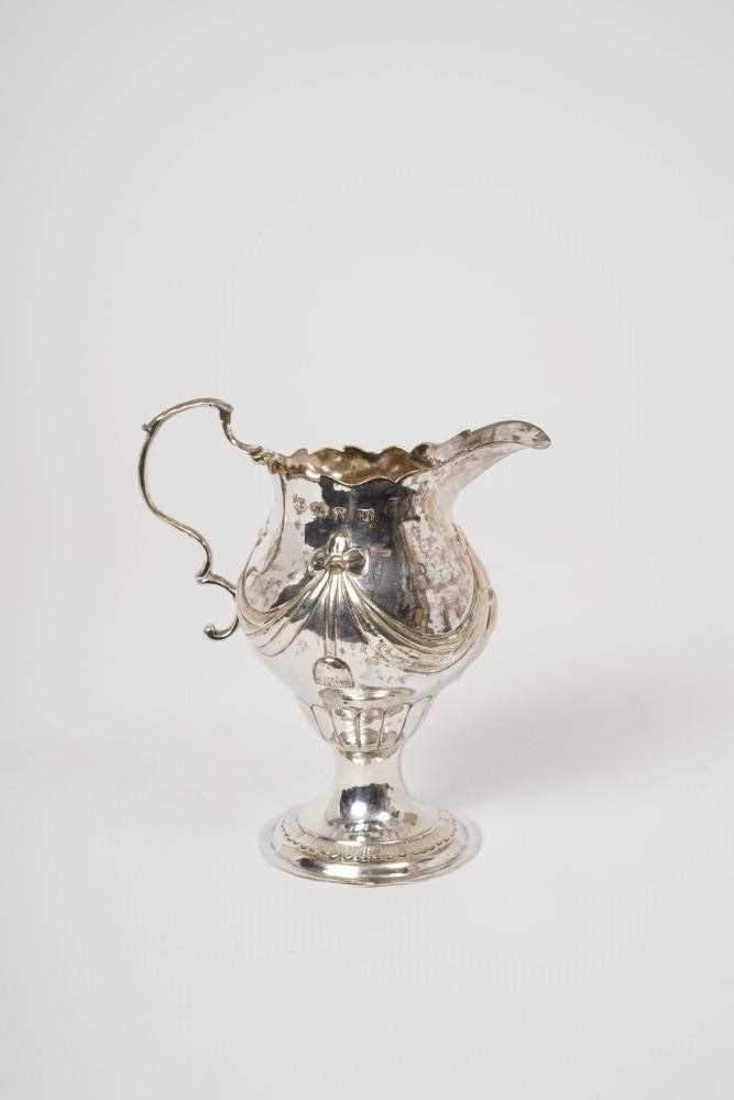 Lot 234 - George III silver cream jug of baluster form, with raised swag decoration