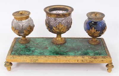 Lot 725 - 19th century malachite and ormolu desk stand, with three glass vessels raised on toupee feet, 24cm wide