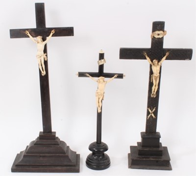 Lot 729 - Three 19th century Continental ivory and ebonised crucifixes, the largest 44cm high