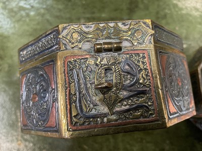 Lot 136 - Two similar Mamluk revival inlaid metalware boxes, each of octagonal form with locking clasp and Islamic script ornament, 9.5cm wide