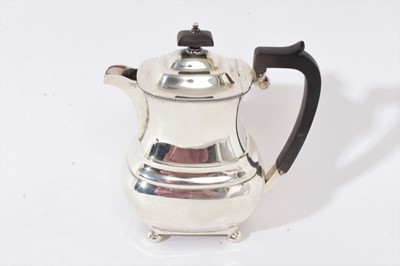 Lot 241 - 1930s silver coffee pot of shaped baluster form, with angular ebony handle and  hinged domed cover