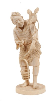 Lot 763 - Good quality Japanese Meiji period carved ivory okimono, depicting a figure with a bird on his shoulder, 19cm high