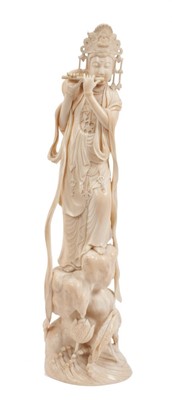 Lot 764 - Fine quality Indo-Chinese carved ivory Krishna figure, depicted playing a flute on naturalistic rocky base, 30cm high