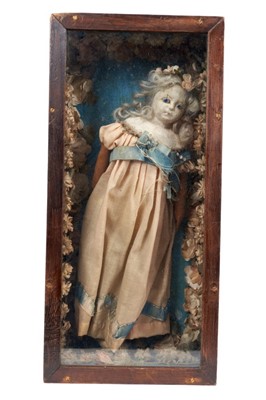 Lot 770 - 18th / 19th century doll or poppet, the carved wooden head doll with inset glass eyes, presented in glazed box with cloth floral embellishments!