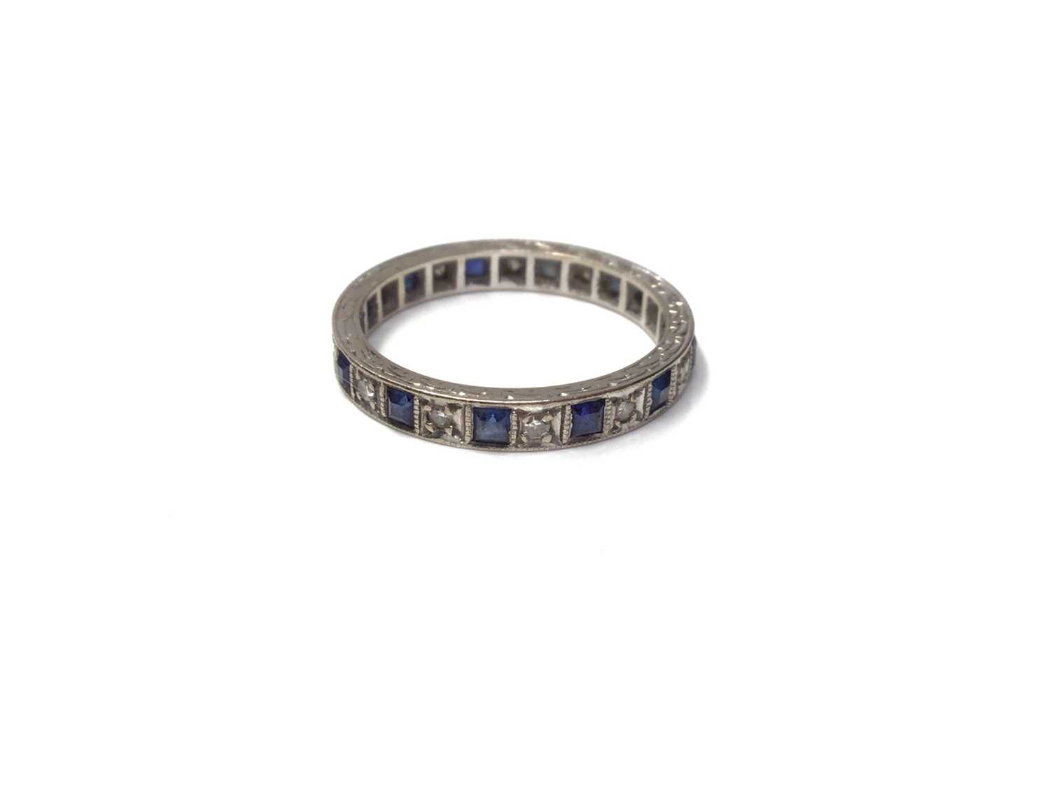 Lot 46 - Diamond and synthetic sapphire eternity ring in white gold setting