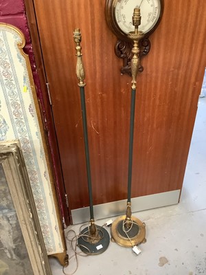 Lot 1109 - Two black painted and gilt metal standard lamps