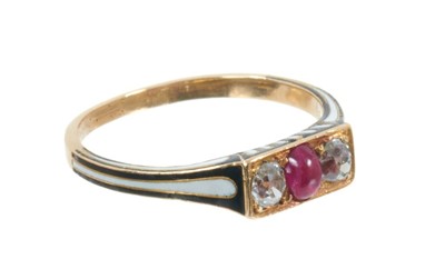 Lot 402 - Good quality antique French ruby, diamond and enamel ring with an oval cabochon ruby flanked by two old cut diamonds, in 18ct yellow gold setting with black and white enamelled decoration. Fleur-de...