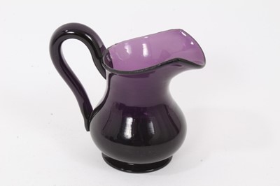 Lot 144 - A 19th century amethyst tinted glass helmet shaped cream jug