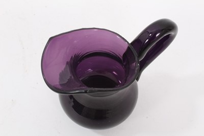 Lot 89 - A 19th century amethyst tinted glass helmet shaped cream jug