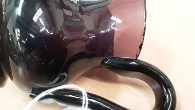 Lot 14 - A 19th century amethyst tinted glass helmet shaped cream jug