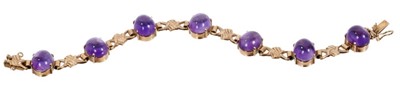 Lot 471 - Cabochon amethyst and gold bracelet with seven oval amethyst cabochons interspaced by 9ct gold links, sponsor's mark 'C&F' Birmingham 1967, length approximately 18.5cm.