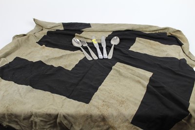 Lot 827 - Second World War Nazi cutlery comprising two knives, two spoons and a fork, each stamped with the Luftwaffe Eagle, together with a very large Swastika, cut from the centre of a flag.