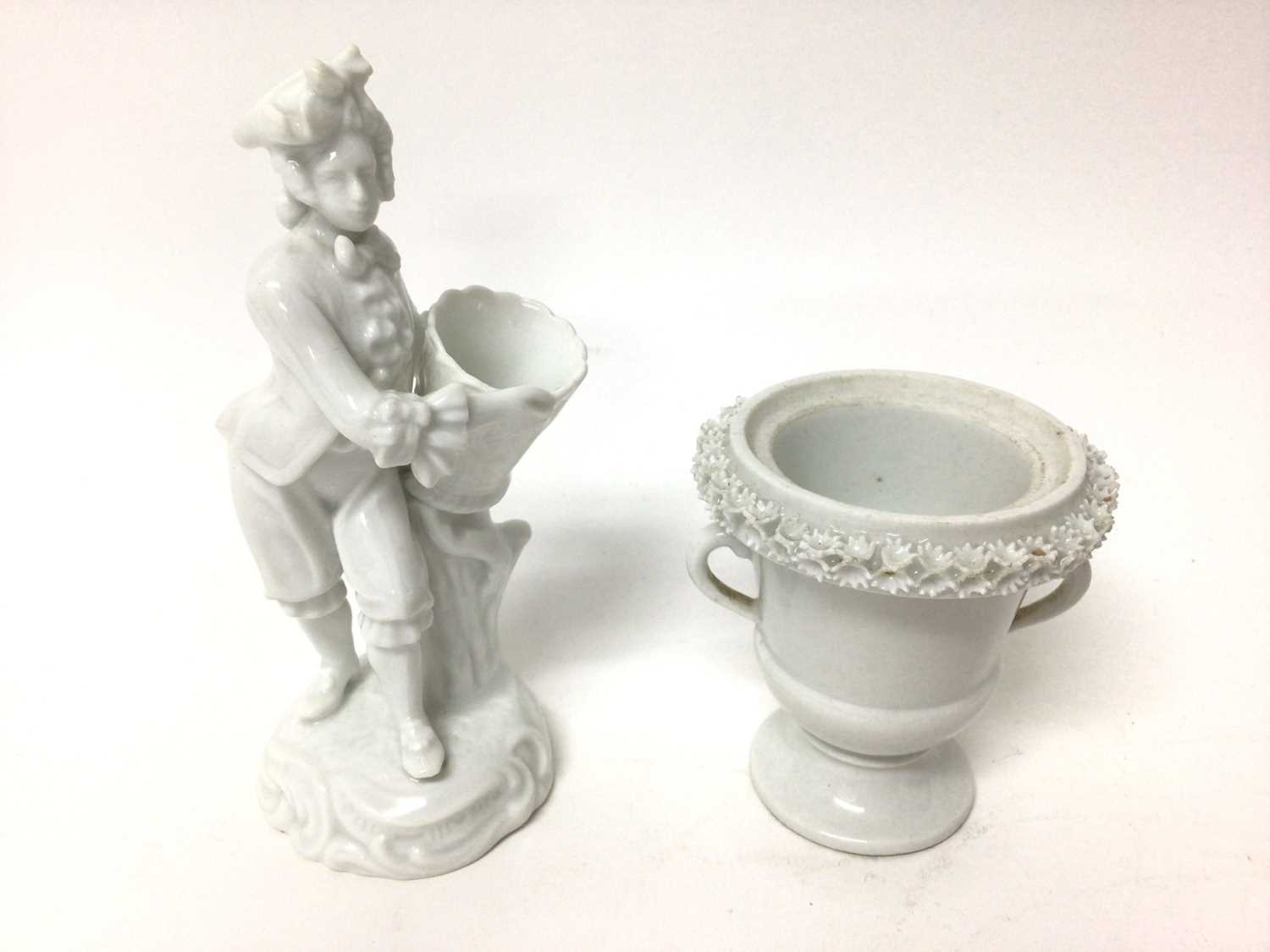 Lot 155 - A Continental porcelain figure with a basket, and a Continental porcelain small two handled vase
