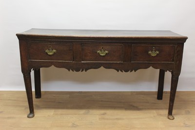 Lot 1373 - George III oak dresser base, with three frieze drawers and wavy frieze on turned legs and pad feet, 141cm wide x 47cm deep x 78cm high