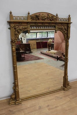 Lot 1375 - Victorian gilt overmantel mirror, with foliate mounded ornament and pierced lattice and spindle panels, rectangular arched plate with flanking projecting cut columns, 146cm wide x 170cm high