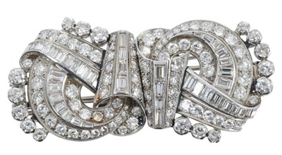 Lot 409 - Art Deco diamond double-clip brooch, the stylized scroll with brilliant cut and baguette cut diamonds in white gold setting, estimated total diamond weight approximately 9cts. Length approximately...